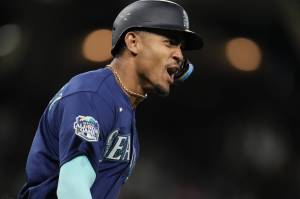 The Mariners Julio Rodriguez reacts after hitting a home run during the eighth inning of a game against the Padres on Tuesday in San Diego. (AP Photo/Gregory Bull)