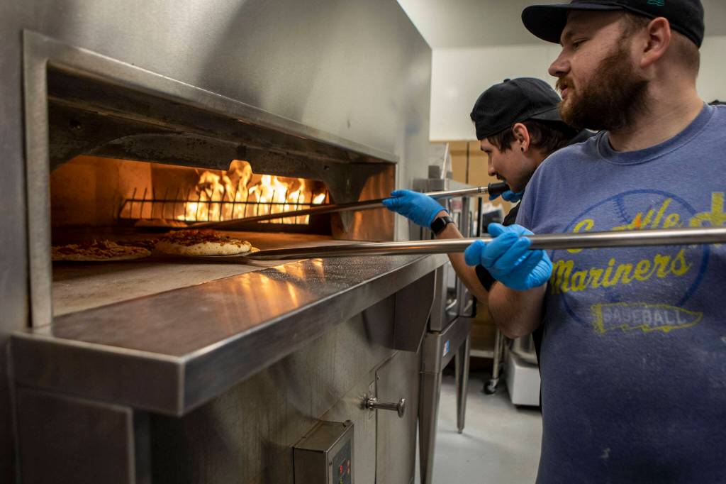 Line cook Kip Dahl, 29, prepares a pizza at the new Sound2Summit taproom in Everett, Washington, on Friday, June 9, 2023. (Annie Barker / The Herald)