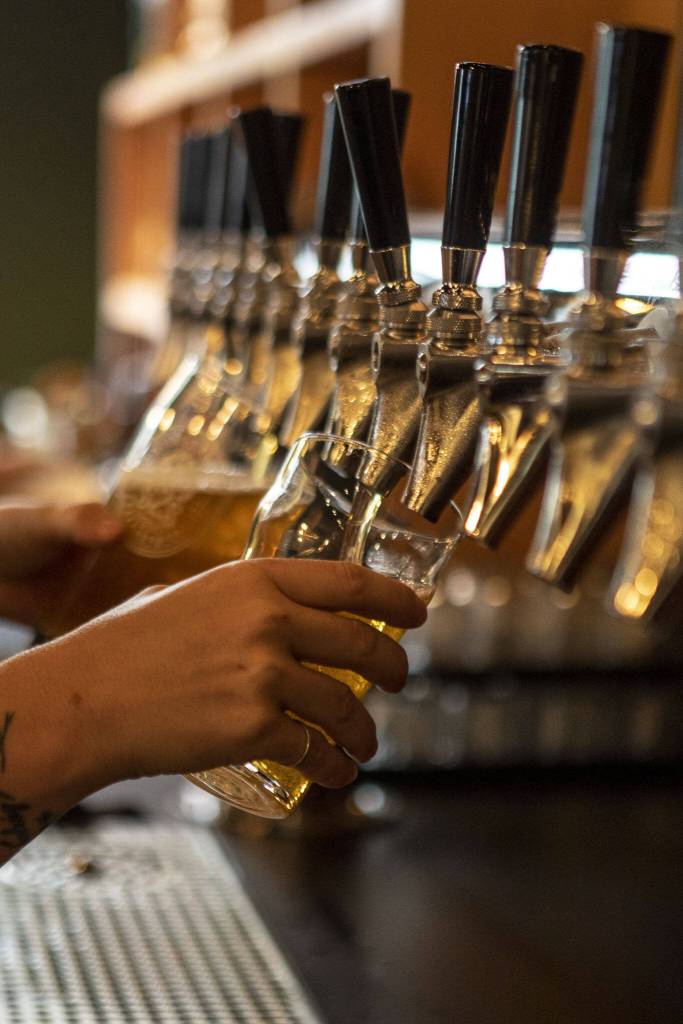 A drink is poured at the new Sound2Summit taproom in Everett, Washington, on Friday, June 9, 2023. (Annie Barker / The Herald)