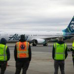 Airport workers watch as an Alaska Airlines Boeing 737 embarks on the first 737 flight out of Paine Field Airport Thursday, Feb. 17, 2022, in Everett, Washington. (Ryan Berry / The Herald)