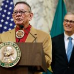 Sen. John McCoy, D-Tulalip, left, speaks Wednesday, Feb. 22, 2017, as Washington Gov. Jay Inslee, right, looks on at the Capitol in Olympia, Washington. (AP Photo/Ted S. Warren)