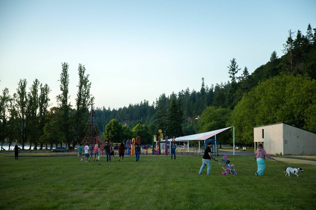 Some folks pack it up for the night while others continue to play after sunset at Kayak Point on Monday, June 12, 2023, in Stanwood, Washington. (Ryan Berry / The Herald)
