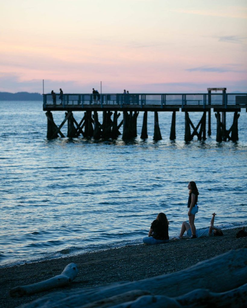 People take in the view moments after sunset at Kayak Point on Monday, June 12, 2023, in Stanwood, Washington. (Ryan Berry / The Herald)