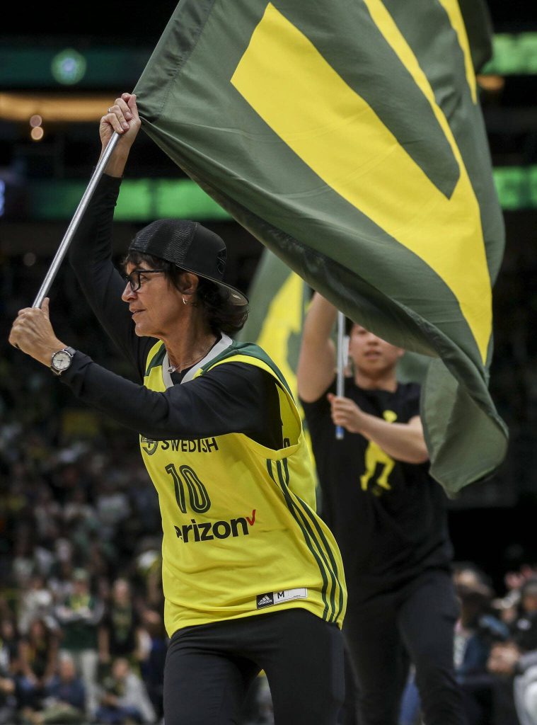 Flags are run across the court during a WNBA basketball game in Seattle, Washington on Sunday, June 11, 2023. The Storm fell, 71-65. (Annie Barker / The Herald)