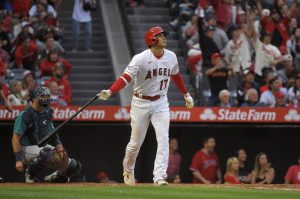 The Angels Shohei Ohtani drops his bat after hitting a two-run home run as Mariners catcher Cal Raleigh watches during the third inning of a game Friday in Anaheim, Calif. (AP Photo/Mark J. Terrill)