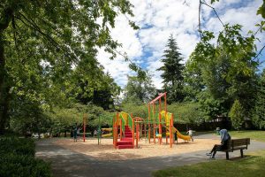 Children play on the playground at Spruce Park, near where two teenagers were shot and killed in a drive-by shooting the night before, on Friday, July 15, 2022, in Lynnwood, Washington. (Ryan Berry / The Herald)