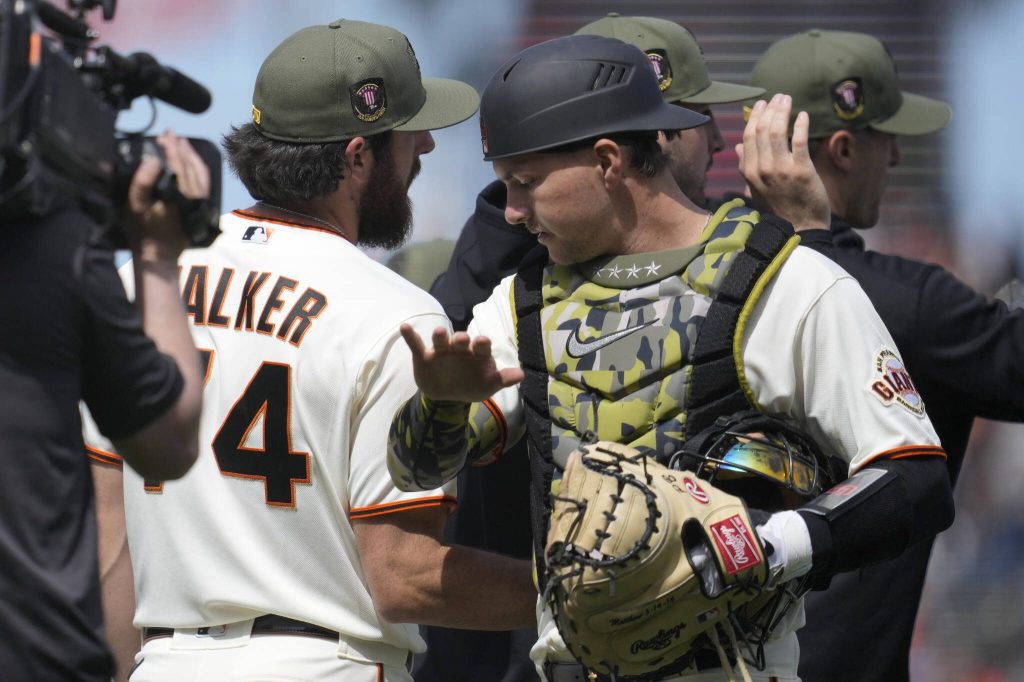 Giants pitcher Ryan Walker (left) celebrates with catcher Patrick Bailey after a win over the Marlins on May 21 in San Francisco. (AP Photo/Jeff Chiu)