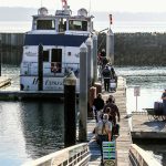 Passengers board the Hat Island Ferry. (Dan Bates / The Herald)