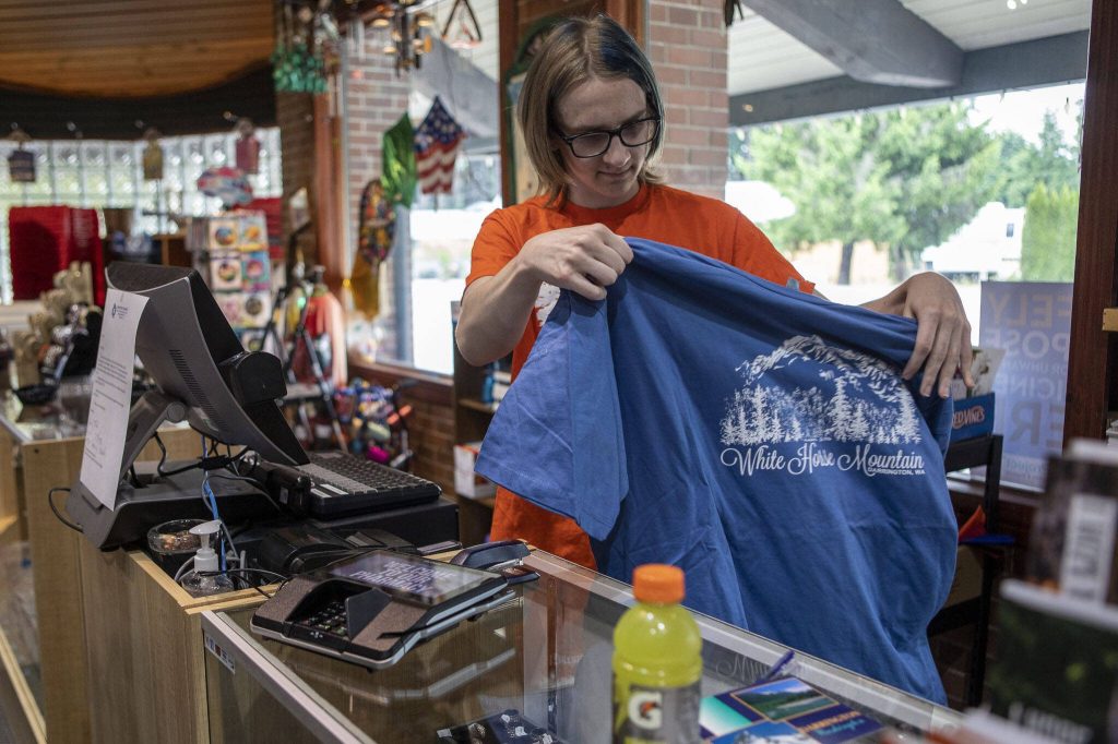 Sheila Sisneys son Jordan, 17, works at the front counter of the Darrington Pharmacy in Darrington, Washington on Friday, June 16, 2023. The pharmacy is closing on July 21, 2023. (Annie Barker / The Herald)