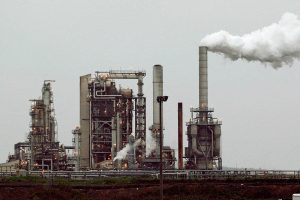 ADDS THAT THE REFINERY'S CURRENT OWNER IS ANDEAVOR - FILE - This April 2, 2010 file photo shows a refinery owned by Andeavor, formerly Tesoro Corp. including a gas flare flame that is part of normal plant operations, in Anacortes, Wash. A campaign bankrolled by the oil industry has raised $20.46 million to defeat a carbon pollution fee on the ballot in Washington state aiming at tackling climate change. (AP Photo/Ted S. Warren, File)