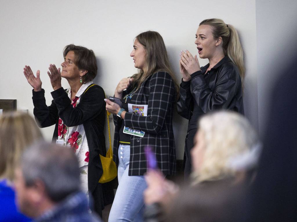 Audience members sing along and cheer on Anna Illyin during her World Refugee Day performance at Everett Community College on Tuesday, June 20, 2023 in Everett, Washington. (Olivia Vanni / The Herald)