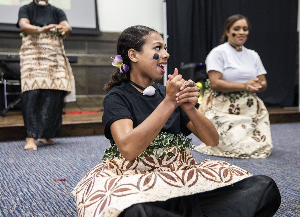 Members of Destinee Fijian Dance Troupe perform while representing the islands of Fiji and Tonga during World Refugee Day at Everett Community College on Tuesday, June 20, 2023 in Everett, Washington. (Olivia Vanni / The Herald)