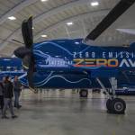 People look at an airplane on display during an event for Alaska Airlines and ZeroAvia to discuss their new collaboration in Everett, Washington on Monday, May 1, 2023. ZeroAvia is developing a hydrogen electric propulsion system for aircraft. (Annie Barker / The Herald)