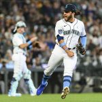 Seattle Mariners third baseman Eugenio Suarez, right, reacts after getting an out against Chicago White Sox's Zach Remillard after recovering a bunt during the ninth inning of a baseball game, Sunday, June 18, 2023, in Seattle. (AP Photo/Caean Couto)