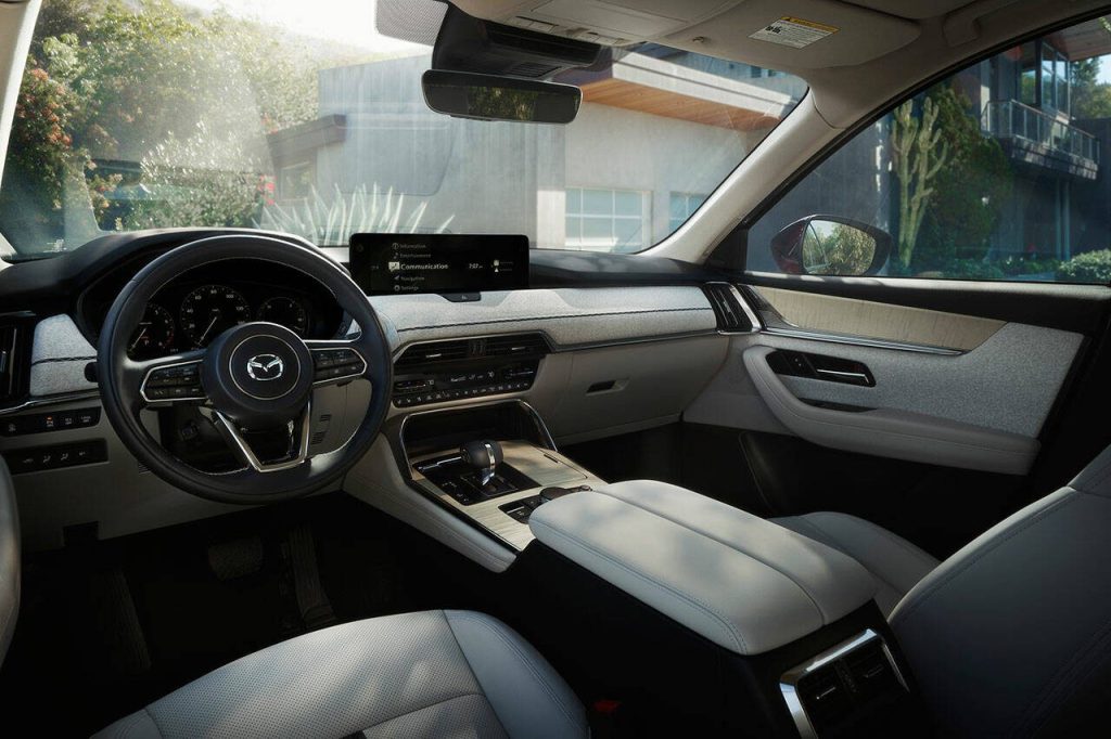 High-end models of the 2024 Mazda CX-90 have rich fabric upholstery on the dashboard. (Mazda)
