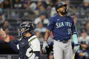 The Mariners Teoscar Hernandez (35) reacts to a swinging strike against Yankees relief pitcher Clay Holmes in the ninth inning of a game Tuesday in New York. (AP Photo/John Minchillo)