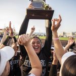 Jackson’s Yanina Sherwood lifts the district trophy in the air after beating Bothell to become the 3A district champions on Friday, May 19, 2023 in Everett, Washington. (Olivia Vanni / The Herald)