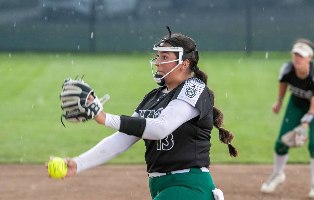 Jackson High School’s Yanina Sherwood (13), pitches as the rain begins to come down during the WIAA class 4A state softball title game on Sat., May 27, 2023, in Richland, Wash. (TJ Mullinax/for The Herald)