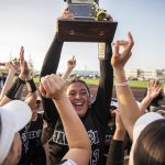 Jackson’s Yanina Sherwood lifts the district trophy in the air after beating Bothell to become the 3A district champions on Friday, May 19, 2023 in Everett, Washington. (Olivia Vanni / The Herald)