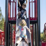 Zoey Odell, 3, plays on a slide at the Hazel Miller Universally Accessible Playground at Ballinger Park in Mountlake Terrace, Washington on Wednesday, June 28, 2023. (Annie Barker / The Herald)