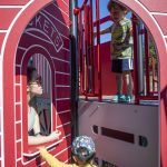 Left to right, Abby Sham, 31, Rowan Sham, 2, and Taka Swaback, 3, play on a structure at the Hazel Miller Universally Accessible Playground at Ballinger Park in Mountlake Terrace, Washington on Wednesday, June 28, 2023. (Annie Barker / The Herald)