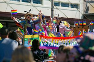 A float full of people dressed as butterflies crawls past thousands celebrating on First Street during Snohomish’s inaugural Pride celebration on Saturday, June 3, 2023, in downtown Snohomish, Washington. (Ryan Berry / The Herald)