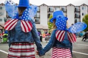 Audri Acosta, 8, and Valentina Acosta, 4, pose for a picture of their watching American flag fairy wings during the Colors of Freedom Fourth of July Parade on Thursday, July 4, 2019 in Everett, Wash. (Olivia Vanni / The Herald)