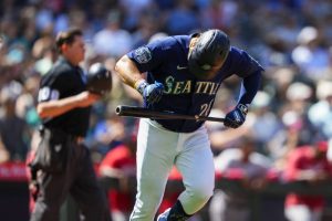 Seattle Mariners' Eugenio Suarez hits his bat as he flies out during a baseball game against the Washington Nationals, Wednesday, June 28, 2023, in Seattle. (AP Photo/Lindsey Wasson)