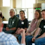 Representatives from different government organizations listen to a Harrington Lagoon resident speak about PFAS found in their drinking water during a public forum on Thursday, June 22, 2023, at the Coupeville Recreation Hall in Coupeville, Washington. From left are Claire Nitsche of the Department of Health, DOH Regional Manager Derek Pell, DOH toxicologist Barbara Morrissey, Department of Ecology’s Kim Wooten and Island County hydrogeologist Chris Kelley. (Ryan Berry / The Herald)