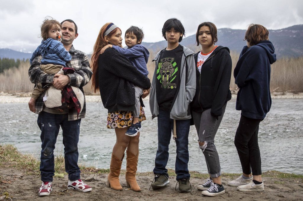 Shawn Haggard and Khrista Bill, at left, stand with their children near the Sauk-Suiattle Reservation in Darrington, Washington on Thursday, March 23, 2023. (Annie Barker / The Herald)