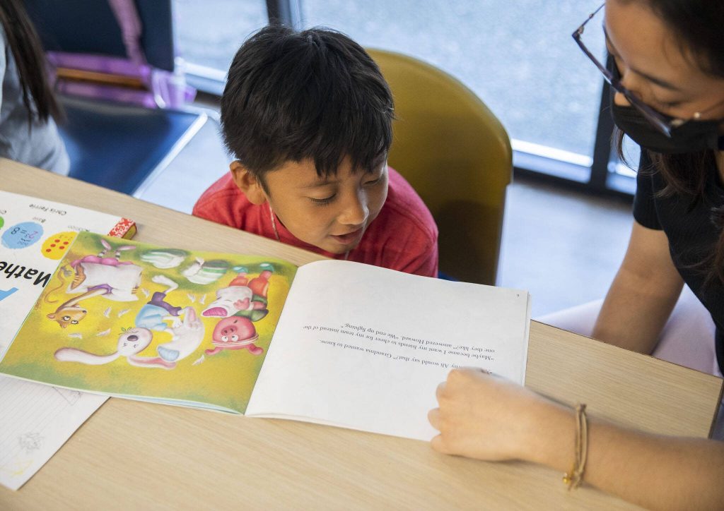 Mateo Vasquez reads aloud to a tutor. (Olivia Vanni / The Herald)