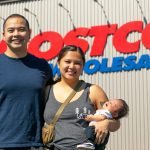 Angelo and Jona Sarmiento, along with baby Carlisle, stand in front of the Lake Stevens Costco where Jona went into labor with the couples first child on May 25. (Ryan Berry / The Herald)