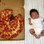 Carlisle Reyes Sarmiento with a slice missing from a Costco pizza to mark his one-month birthday on June 26. His mother, Jona Sarmiento, went into labor at the Lake Stevens Costco a month earlier. (Submitted photo)