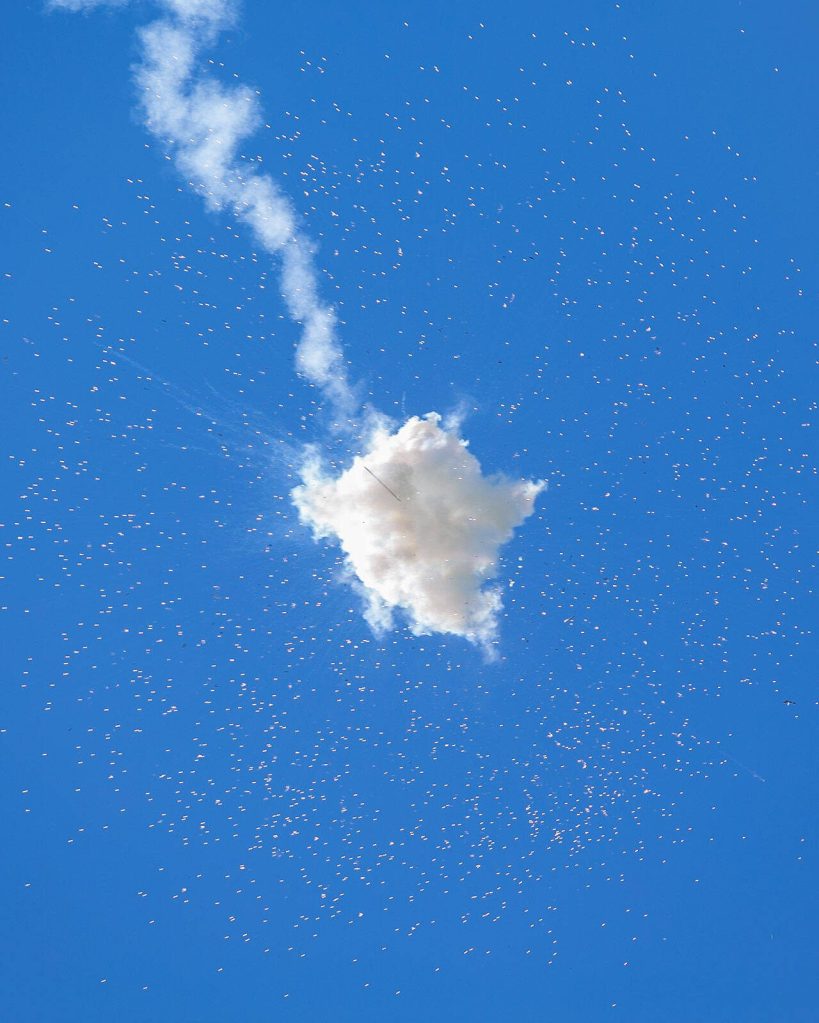 A rocket explodes in the sky as people launch off different fireworks at Boom City on July 1, 2023, in Tulalip, Washington. (Ryan Berry / The Herald)