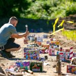 Andrei Pocol, of Seattle, lights off a rocket he bought at Boom City on July 1, 2023, in Tulalip, Washington. (Ryan Berry / The Herald)