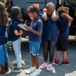 Binta Sanneh, 5, left, and Binta Sanneh, 6, right, line up along with other Rise Up Academy students to get a chance to climb into a truck on Thursday, July 6, 2023 in Everett, Washington. (Olivia Vanni / The Herald)