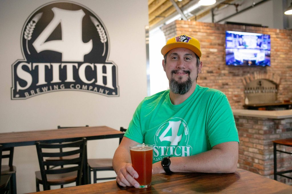 4 Stitch Brewing Company owner and brewer Matt Pereira sits near the front door of his new brewery on Friday, June 23, 2023, in Mill Creek, Washington. The family-run business opened at its 9th Avenue SE location in the spring. (Ryan Berry / The Herald)