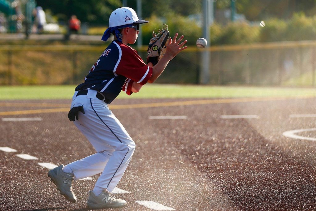 Everett All Star Ethan Nelson charges and fields a grounder at third against Lake Stevens during a 12u Little League matchup on Wednesday, July 5, 2023, at the Phil Johnson Ballfields in Everett, Washington. (Ryan Berry / The Herald)