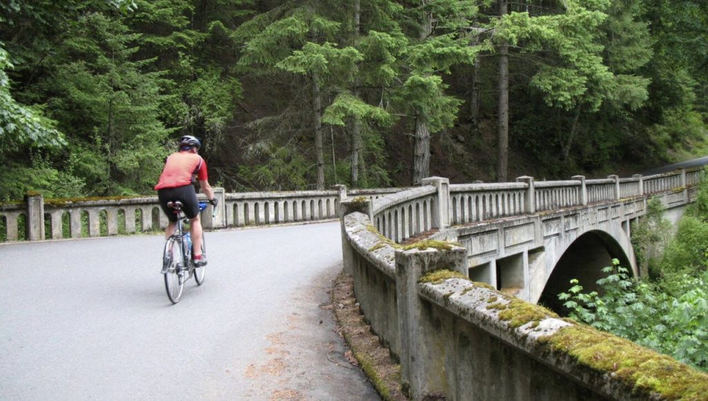 A cyclist rides across a bridge in Moran State Park on Orcas Island. The park covers 5,424 acres in the islands interior. (Carey J. Williams / Associated Press)