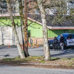 People survey the scene of a shooting along Highway 99 on Wednesday, March 22, 2023 in Everett, Washington. (Olivia Vanni / The Herald).