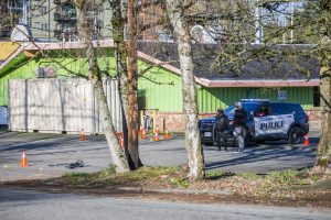 People survey the scene of a shooting along Highway 99 on Wednesday, March 22, 2023 in Everett, Washington. (Olivia Vanni / The Herald).