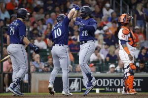 The Mariners Eugenio Suarez (28) celebrates with Jarred Kelenic after hitting a home run during the second inning of a game Thursday in Houston. (AP Photo/Michael Wyke)