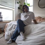 Thavoron poses for a photo at his apartment on Saturday, April 8, 2023 in Seattle, Washington. (Annie Barker / The Herald)