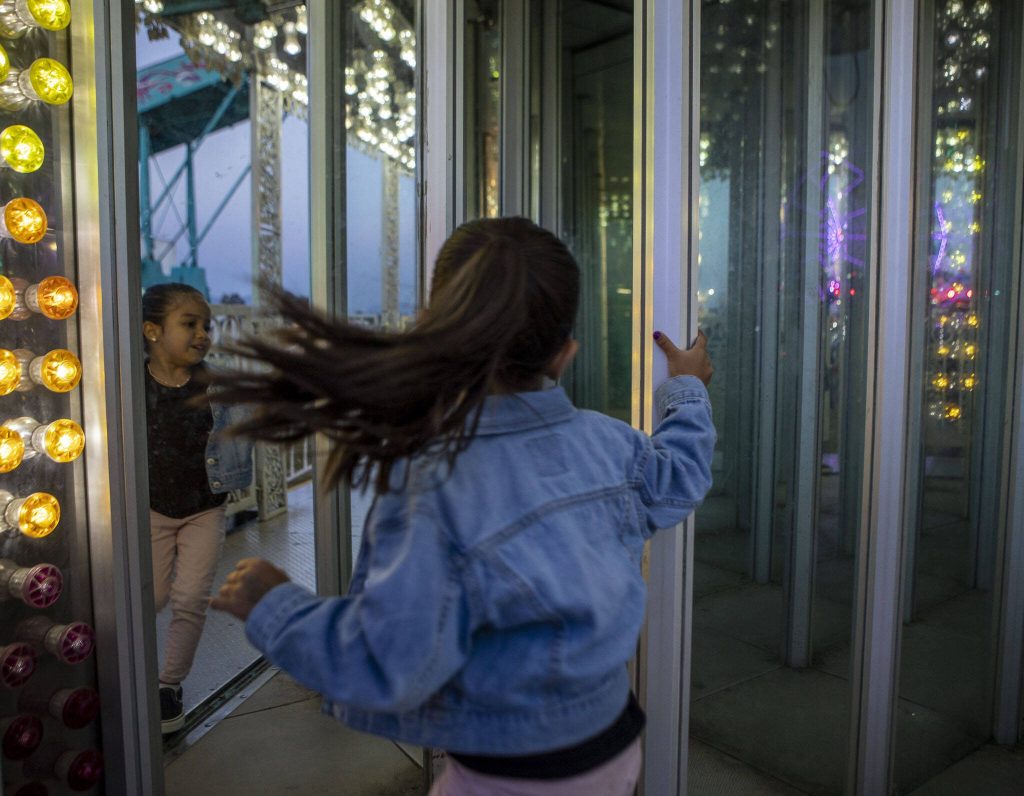 A child enters a house of mirrors during the Kla Ha Ya Days carnival at Harvey Field in Snohomish, Washington on Thursday, July 13, 2023. (Annie Barker / The Herald)