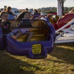 Keala Hew, 7, left, and Riley Alvarado, 7, right, smile on a ride during the Kla Ha Ya Days carnival at Harvey Field in Snohomish, Washington on Thursday, July 13, 2023. (Annie Barker / The Herald)
