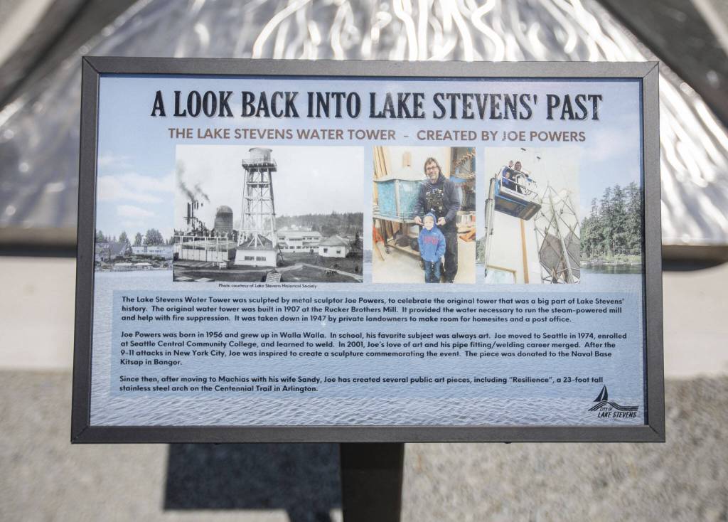 A sign explains the history of the water tower on display in front of the art piece on Thursday, July 20, 2023 in Lake Stevens, Washington. (Olivia Vanni / The Herald)