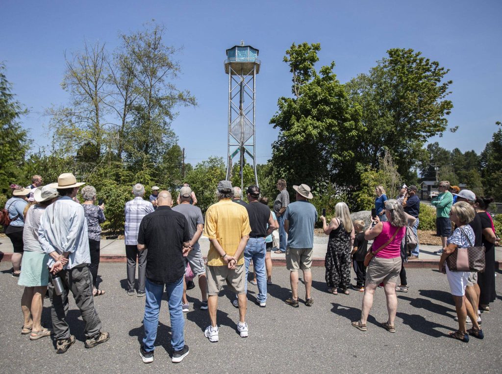 People gather for the ribbon-cutting ceremony of the Lake Stevens Water Tower art piece on Thursday, July 20, 2023 in Lake Stevens, Washington. (Olivia Vanni / The Herald)