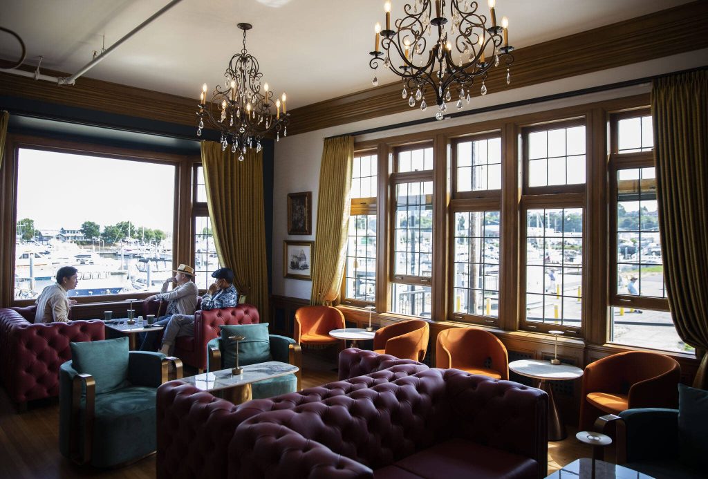 People chat in one of the sitting rooms at the Muse Whiskey & Coffee Bar on Wednesday, July 12, 2023 in Everett, Washington. (Olivia Vanni / The Herald)