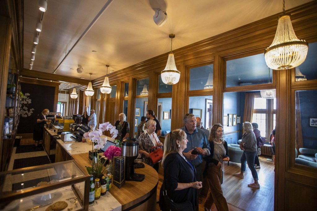 People wander through the Muse Coffee Bar side of the 100-year-old Weyerhaeuser building on Wednesday, July 12, 2023 in Everett, Washington. (Olivia Vanni / The Herald)