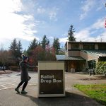 A voter drops off her ballot at the drop box in front of the Mukilteo Library on Tuesday, Nov. 8, 2022, in Mukilteo, Washington. (Ryan Berry / The Herald)